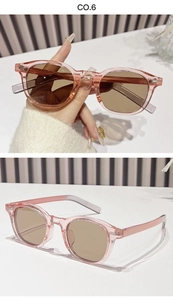 Detail view of pink oval leopard print sunglasses with brown lenses and metal rivets