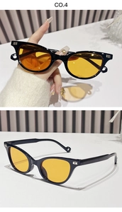 Detail of black cat-eye sunglasses with yellow lenses and silver letter B temple accent