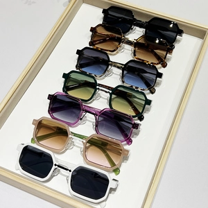 Vintage hip-hop small square sunglasses in various colors displayed on a wooden tray