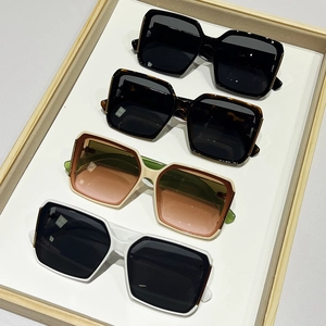 Collection of retro square sunglasses in black, tortoise, and white with gold accents