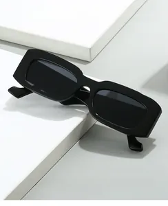 Macro detail of high-quality black rectangular frame sunglasses on geometric prop