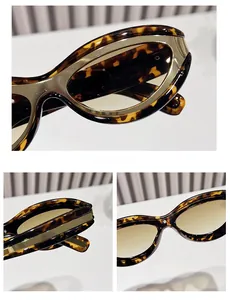Detail of tortoiseshell frames with gold metal trim and brown gradient lenses