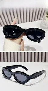 Detail shot of vintage black oval sunglasses with wide thick frames and Y2K retro style