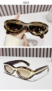 Detail of vintage cat-eye sunglasses featuring tortoiseshell frames and gold metal accents