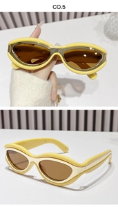 Detail showing retro pale yellow oval sunglasses with inner gold metal frames and brown lenses