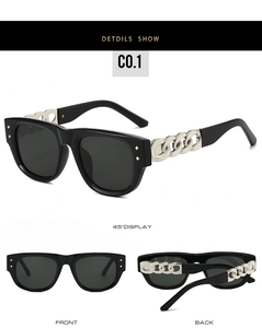 Detail view of square sunglasses featuring black frames and metallic chain temples