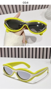 Detail of neon yellow streamlined sunglasses with silver metal decor and UV lenses