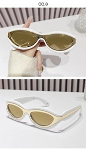 Detail of white chunky cat-eye sunglasses with golden lenses and glossy resin frames