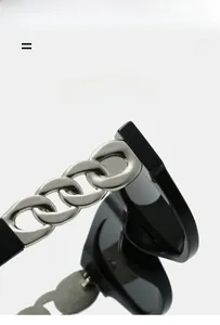 Detail of black sunglasses arm featuring a bold silver metal chain link and texture material