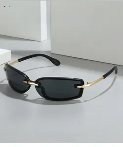 Detail of square rimless sunglasses featuring grey lenses and gold metal temples
