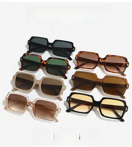 Flat lay of retro square sunglasses in six diverse colors with golden metal accents