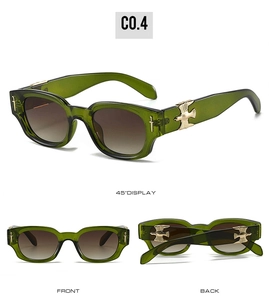 Détail de lunettes vertes avec ornements de branches en métal épée et aigle dorés