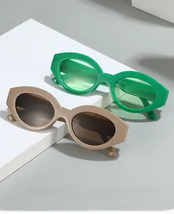 Detail view of oval cat-eye sunglasses in green and brown frames with 50-22-137 size specs