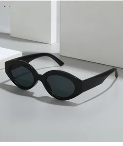 Detail shot of black vintage oval sunglasses with dark grey lenses on geometric props