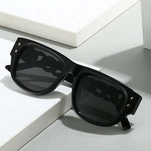 Chic oversized square sunglasses with black frames and decorative silver metal rivets