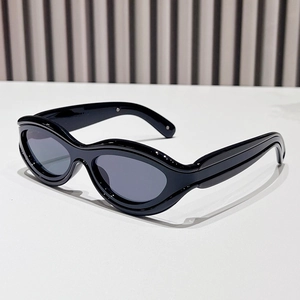 Retro oversized sunglasses with thick wavy black frames and dark grey oval lenses