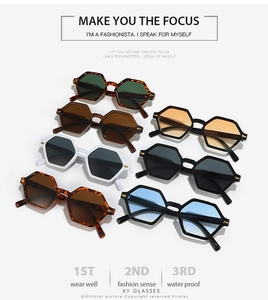 Detail of colorful hexagonal retro sunglasses frames with gold metal hinges and lenses