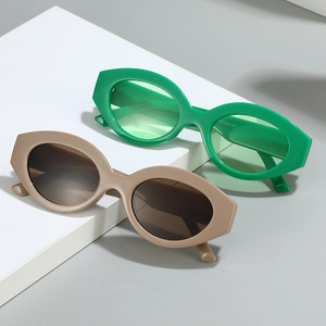 Fashionable retro oval cat eye sunglasses in bright green and khaki plastic frames