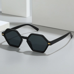 Retro black hexagonal sunglasses with dark lenses and gold metal hinge accents