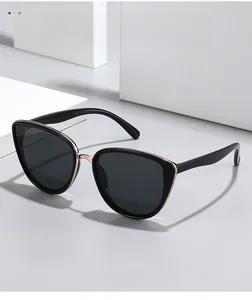 Detail showing the vintage cat eye sunglasses frame with black acetate and gold metal trim