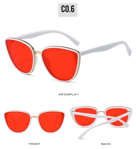 Close-up of vintage cat-eye sunglasses with white frame, red lenses and gold bridge detail