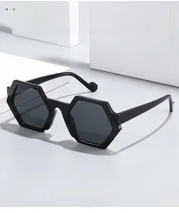 Detail shot of black hexagonal sunglasses on geometric pedestals showing texture