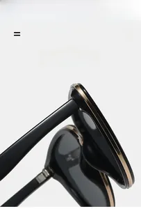 Detail view of cat eye sunglasses with golden metal trim and flexible hinge structure