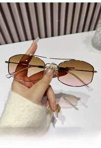 Detailed view of geometric metal sunglasses with brown-to-pink gradient lenses