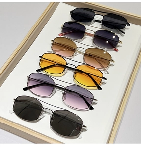 Detail of diverse lens colors and dual bridge metal frames on vintage sunglasses