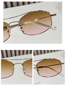 Macro detail of geometric metal frame sunglasses with gradient lenses and double bridge