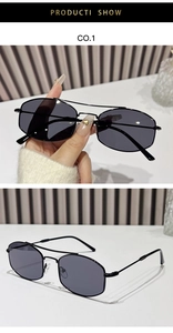 Detail of black geometric metal sunglasses showing double bridge and slender frame