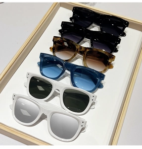 Detailed top view of assorted stylish rectangular sunglasses in a display tray