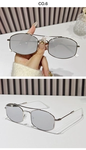Detail of silver double-bridge metal sunglasses with hexagonal frames and white temple tips