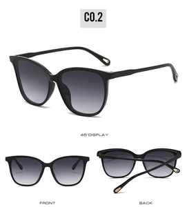 Detail view of cat eye sunglasses with gradient lenses and gold teardrop temple tips
