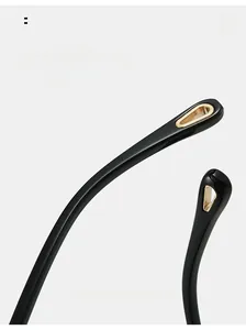 Detail view of curved black eyeglass temples with gold triangular hollow metal decoration