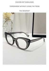 Close-up of transparent grey cat-eye glasses frame on a minimalist artistic background