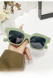 Detail view of light green square oversized sunglasses with dark grey lenses and retro frame