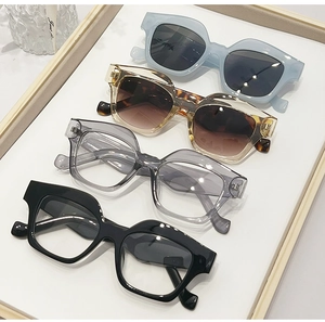 Detailed close-up showing four stylish thick-frame sunglasses in various colors and finishes