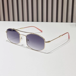 Geometric gold metal sunglasses with purple gradient lenses on a minimalist background
