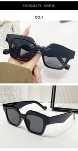 Detail view of bold irregular geometric black sunglasses with thick frames and dark lenses
