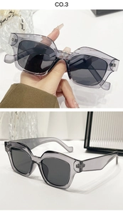 Close-up of translucent grey-purple geometric sunglasses frame with dark grey lenses