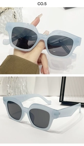 Detail view of stylish square frame sunglasses in light blue with dark lenses
