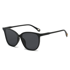 Oversized cat-eye sunglasses in black with gold metal details and dark lenses