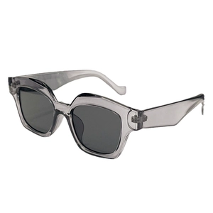 Modern geometric sunglasses with translucent grey frames and dark lenses for women