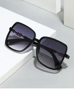 Close-up of stylish black square sunglasses with gradient lenses and metallic temple detail