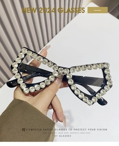 Macro detail of luxury oversized butterfly frames with hand-set crystal embellishments