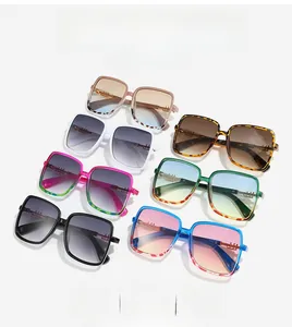 Flat lay of oversized square sunglasses in seven vibrant colors with gradient lenses