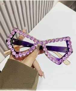 Detail of purple oversized glasses frame with sparkling rhinestones and crystal finish