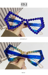 Detail view of oversized butterfly frame glasses with blue rhinestones and transparent arms