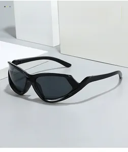 Detail of black cat-eye Y2K sunglasses with dark grey UV lenses on geometric props
